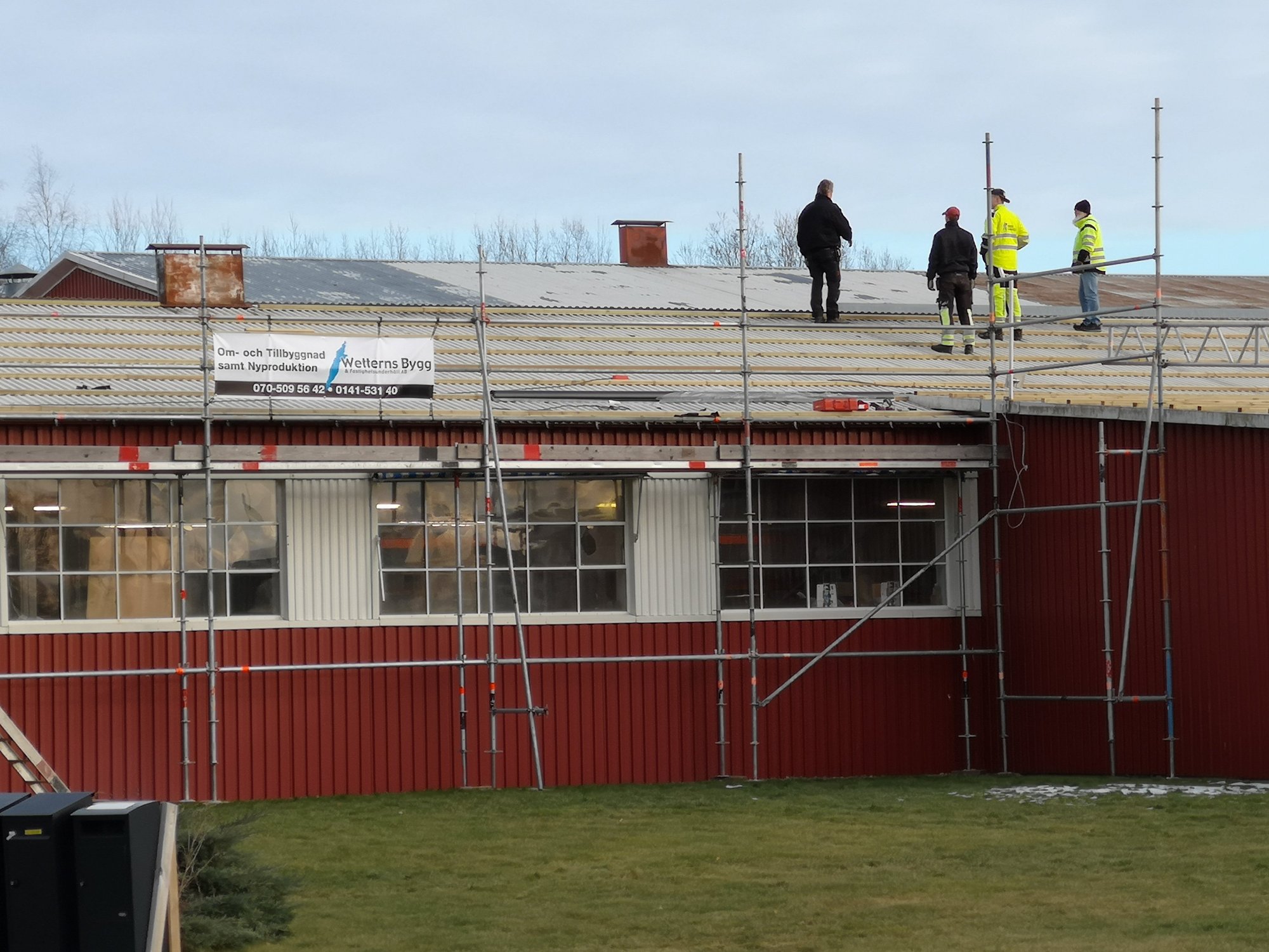 Takarbete med byggställning och Wetterns Byggs skylt